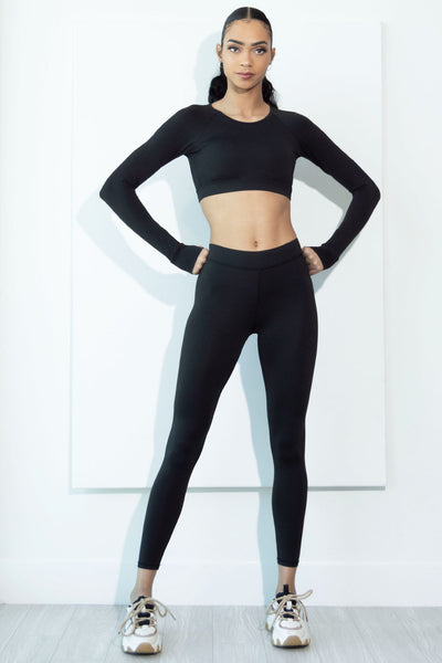 Model wearing our Sia black activewear set full body front view.