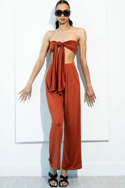 Model wearing our Kali orange bandeau two piece pant set front view.