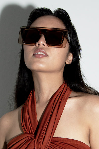 Model wearing our Mirai tortoise shell square sunglasses three quarter front view.