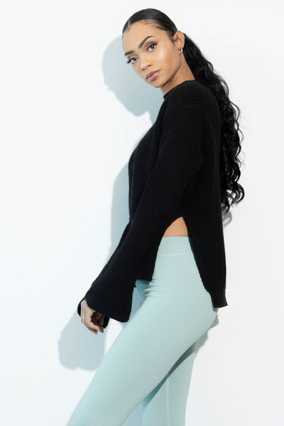 Model wearing our Ilaria black sweater side view.